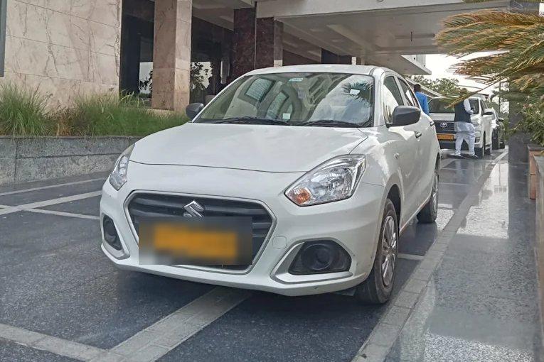 Our white Maruti Suzuki Dzire, photographed on a hotel forecourt in Jaipur